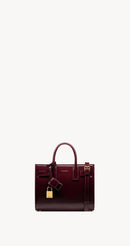 Yves Saint Laurent - SAC DE JOUR NANO EN CUIR VERNI
DARK RED WINE