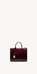 Yves Saint Laurent - SAC DE JOUR NANO EN CUIR VERNI
DARK RED WINE