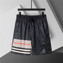 Burberry - Shorts avec motif monogramme et bande colorée - Noir