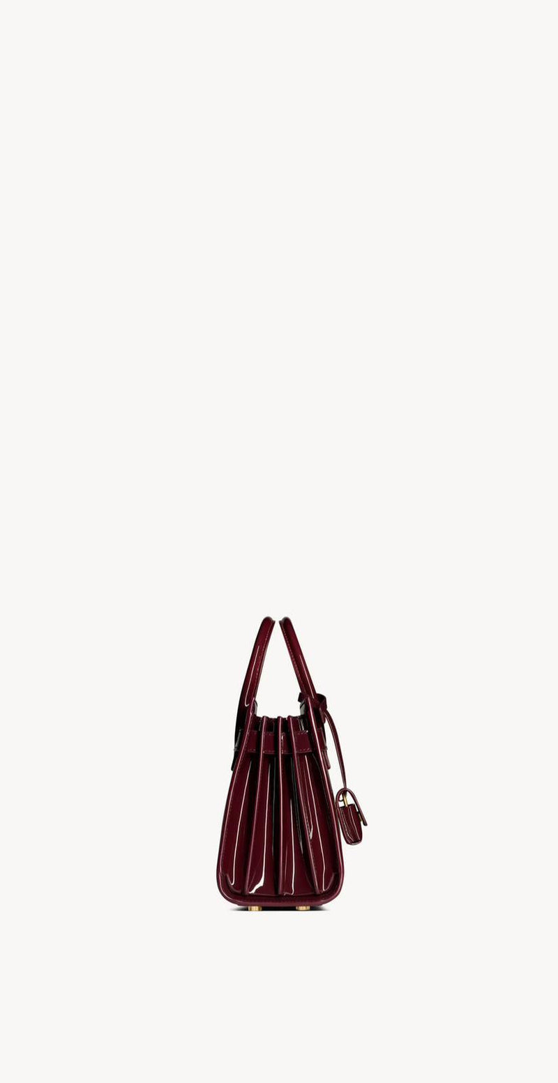 Yves Saint Laurent - SAC DE JOUR NANO EN CUIR VERNI
DARK RED WINE